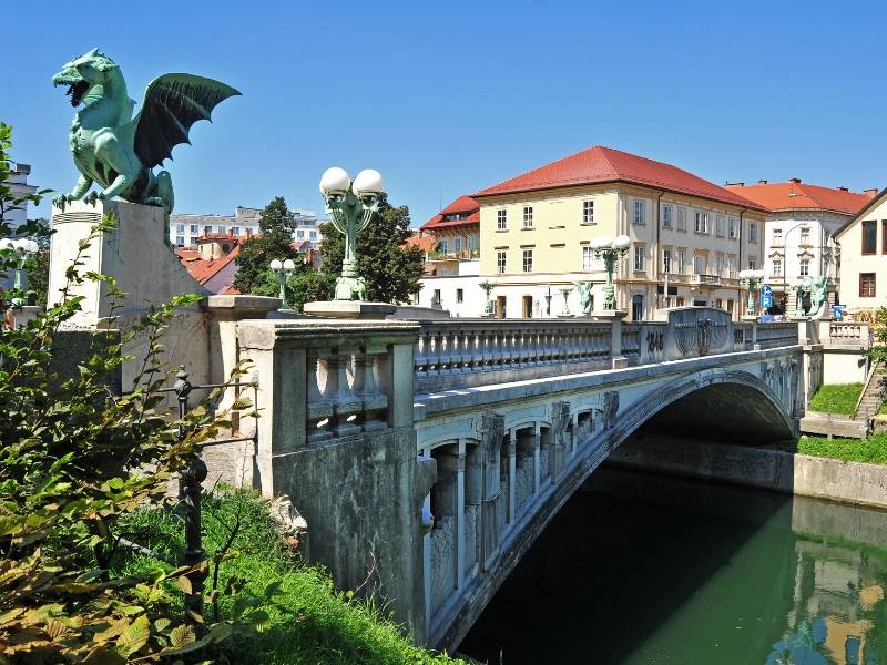 A bridge with dragon statues along it in Ljubljana
