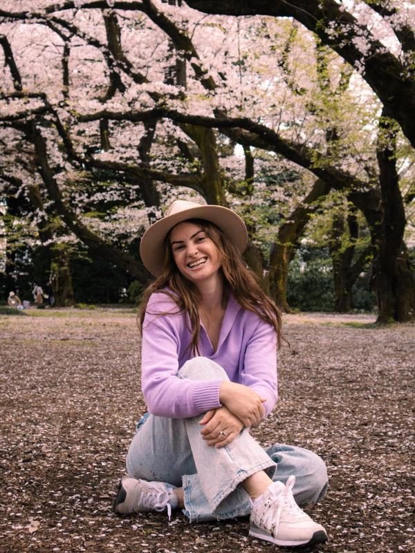 Tess Moone sitting with cherry blossom - guest in episode 46 of the GTP Podcast.