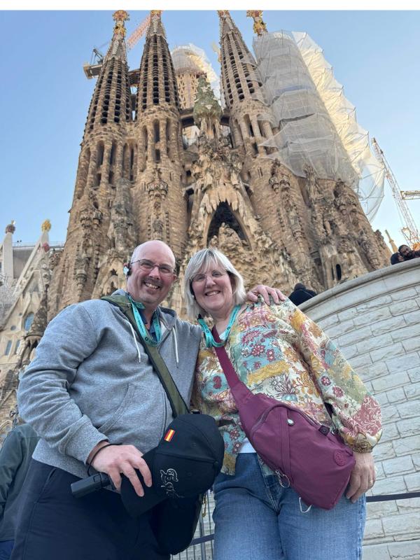 Man and lady standing in front of La Sagrada Familiar in Barcelona.