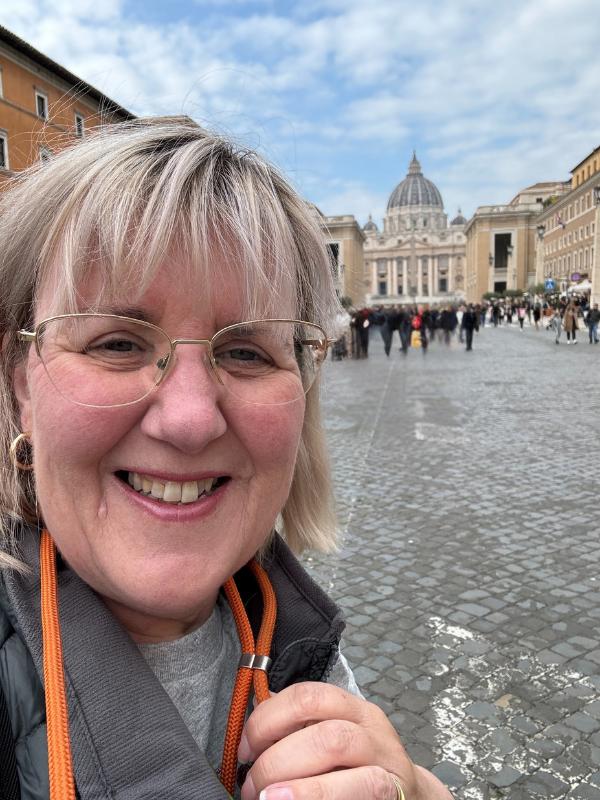Lady with Vatican behind her.