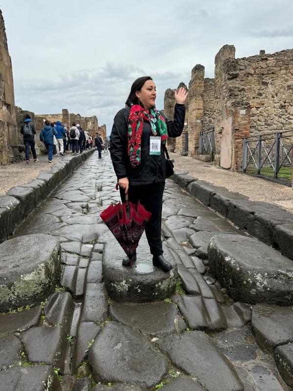 Lady standing on a stone in Pompeii.