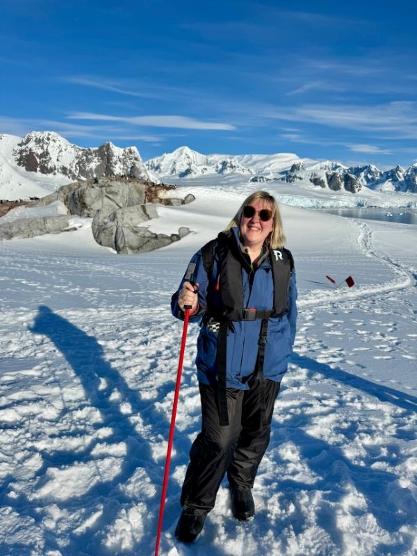 Tracy in waterproofs casting a long shadow on the ice in Antarctica